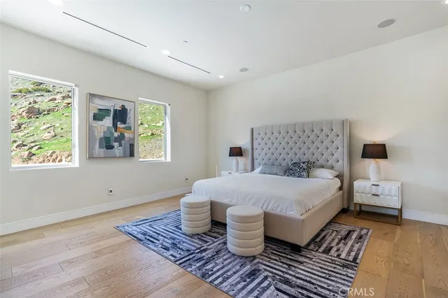 a living room with furniture a flat screen tv and a painting on the wall