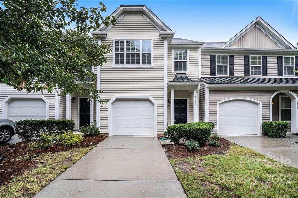 13206 Erwin Road Charlotte, NC 28273 - Photo 1 of 26 a front view of a house with garden