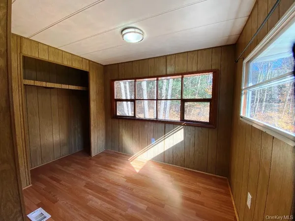 a view of a room with wooden floor and windows