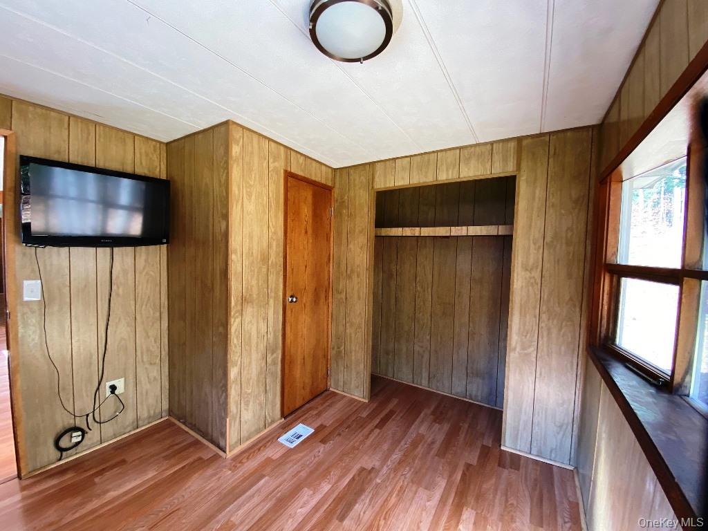141 Gale Road Mongaup Valley, NY 12762 - Photo 13 of 20 a view of a room with wooden floor and windows