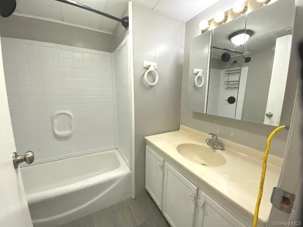 a white toilet sitting next to a sink and vanity