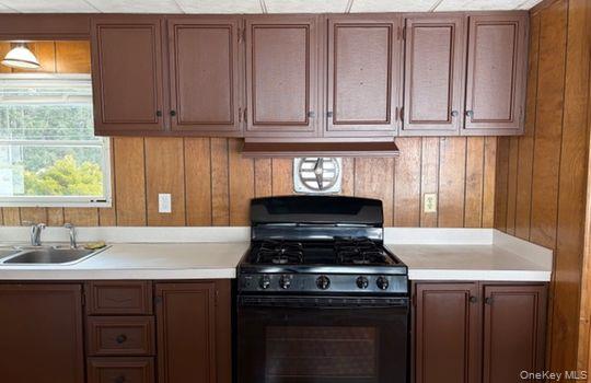 141 Gale Road Mongaup Valley, NY 12762 - Photo 4 of 20 a kitchen with granite countertop a stove sink and cabinets