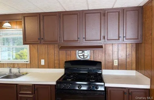 a kitchen with granite countertop a stove and a sink