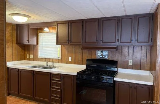a kitchen with a sink stove and cabinets