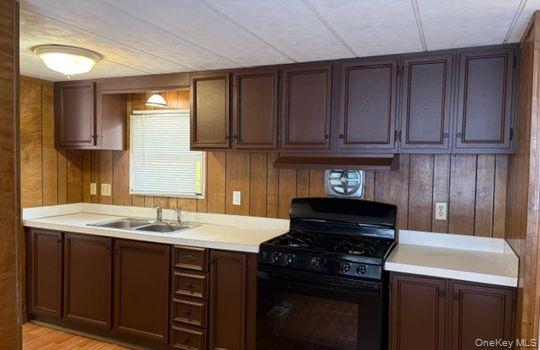 141 Gale Road Mongaup Valley, NY 12762 - Photo 8 of 20 a kitchen with a sink stove and cabinets