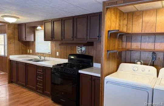 a kitchen with a stove cabinets and a sink