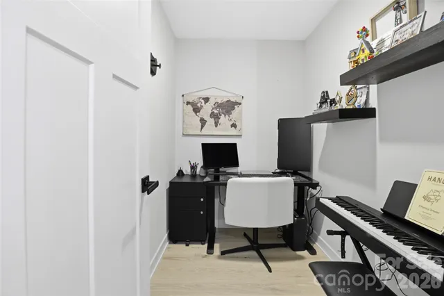 a view of a workspace with furniture and a gate