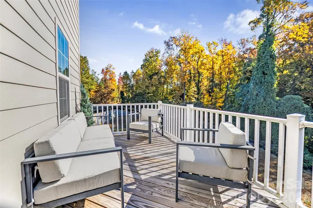 a view of balcony with wooden floor and fence