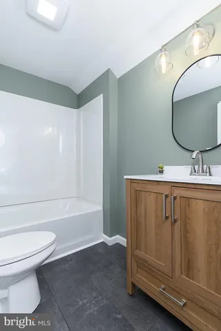 a bathroom with a toilet a sink and bathtub