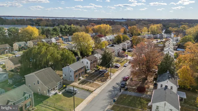 a view of a white house with large windows next to a road