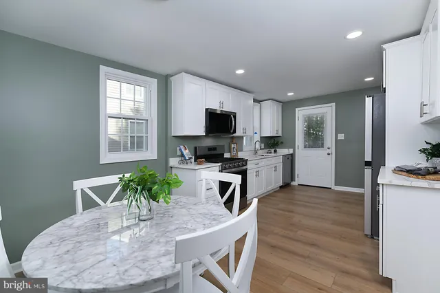 a kitchen with furniture and a wooden floor