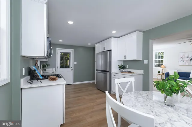a kitchen that has a lot of cabinets a sink and appliances in it