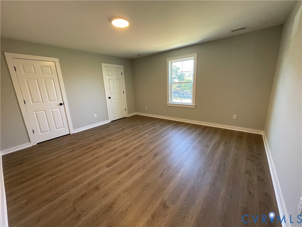 12234 Old Chula Road, Unit 2 Amelia Court House, VA 23002 - Photo 11 of 13 an empty room with wooden floor and windows