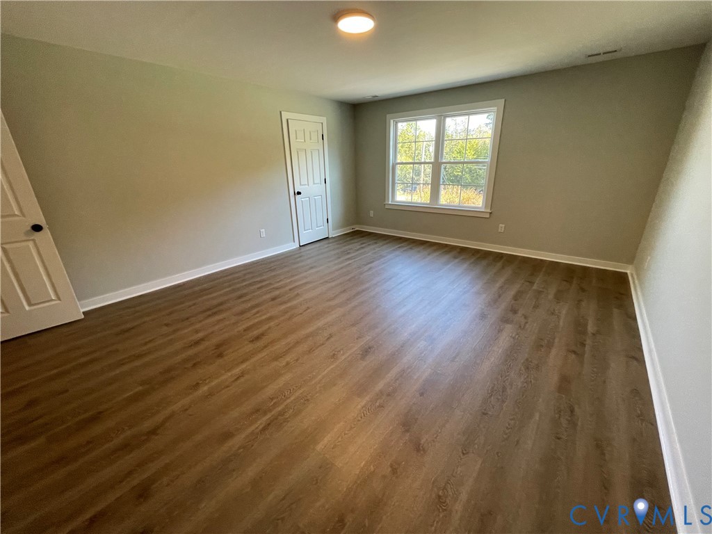 12234 Old Chula Road, Unit 2 Amelia Court House, VA 23002 - Photo 12 of 13 an empty room with wooden floor and windows