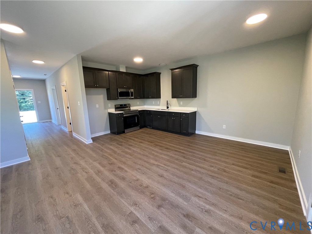 12234 Old Chula Road, Unit 2 Amelia Court House, VA 23002 - Photo 9 of 13 a large kitchen with stainless steel appliances kitchen island a large counter top a stove and a wooden floors