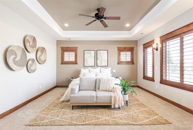 a spacious bedroom with a bed and ceiling fan