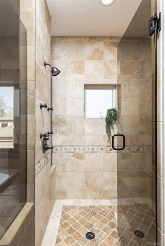 a bedroom with a bed two couch and a window