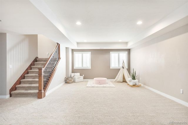 a living room with stainless steel appliances kitchen island furniture and a flat screen tv