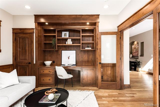 a living room with furniture a rug and kitchen view