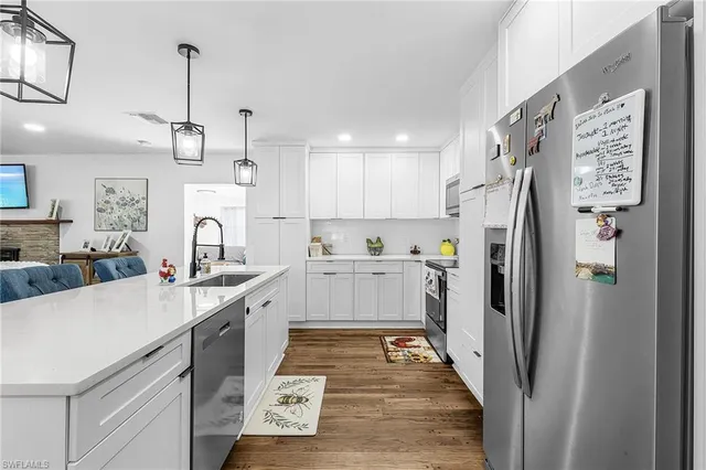 a kitchen with stainless steel appliances a refrigerator sink and cabinets
