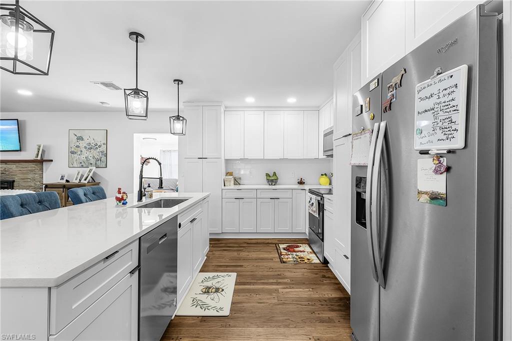 3843 Marvaez Street Fort Myers, FL 33901 - Photo 11 of 26 a kitchen with stainless steel appliances a refrigerator sink and cabinets