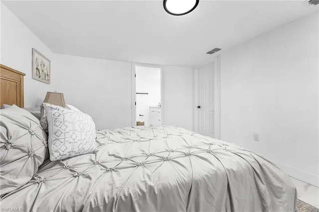 a bed with white sheets and a white bed