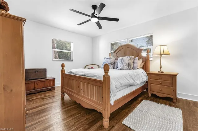 a bedroom with a bed wooden floor and a desk