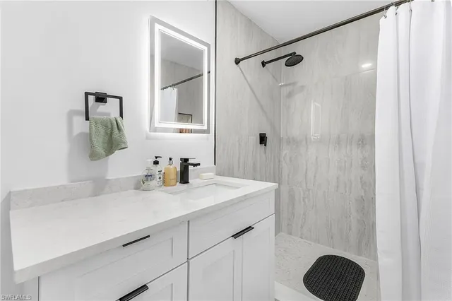 a bathroom with a sink vanity and a mirror