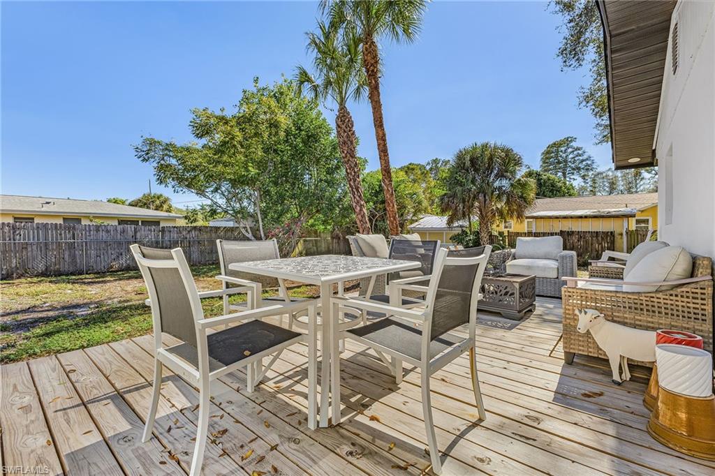 3843 Marvaez Street Fort Myers, FL 33901 - Photo 21 of 26 a view of a patio with dining table and chairs with wooden floor and fence