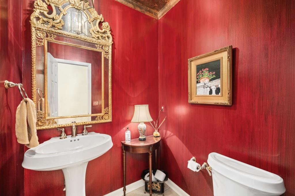 300 Waterpine Court Sandy Springs, GA 30350 - Photo 14 of 53 a bathroom with a toilet sink and mirror