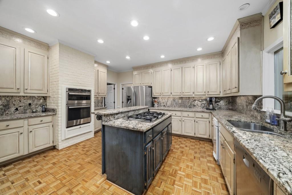 300 Waterpine Court Sandy Springs, GA 30350 - Photo 17 of 53 a kitchen with stainless steel appliances granite countertop a stove top oven a sink dishwasher and a refrigerator with the cabinets