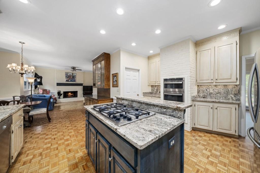 300 Waterpine Court Sandy Springs, GA 30350 - Photo 18 of 53 a kitchen with stainless steel appliances granite countertop a stove top oven a sink dishwasher and a refrigerator with wooden floor