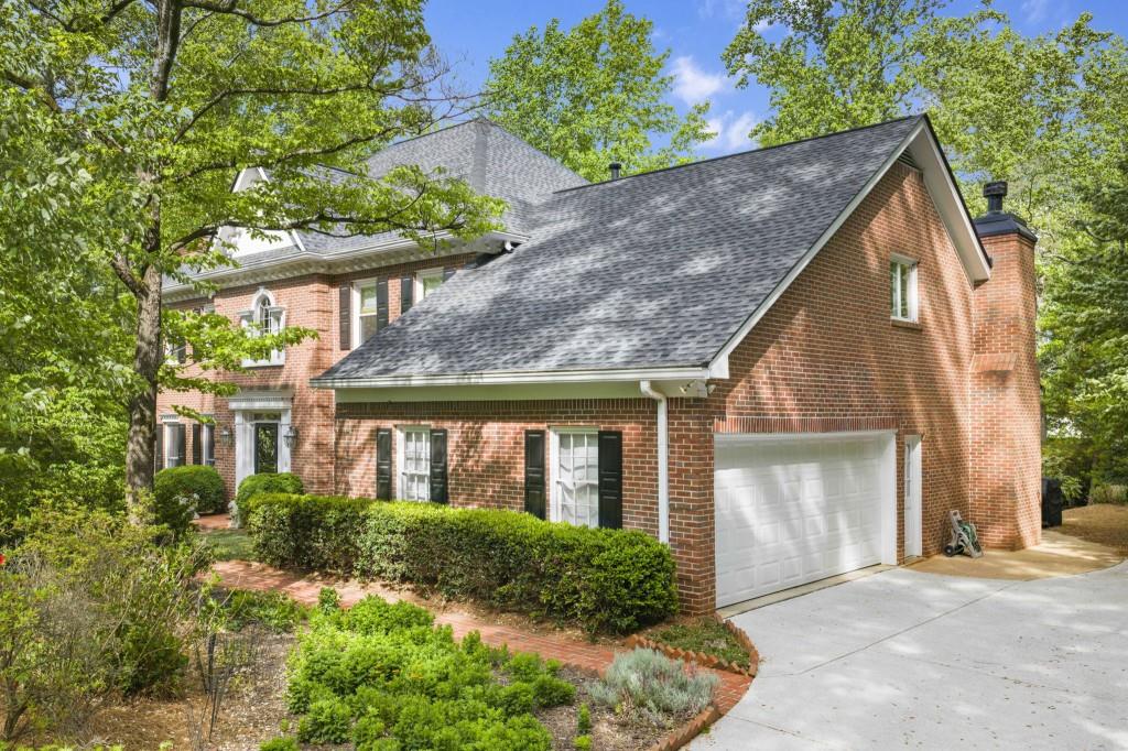 300 Waterpine Court Sandy Springs, GA 30350 - Photo 2 of 53 a front view of house with a garden