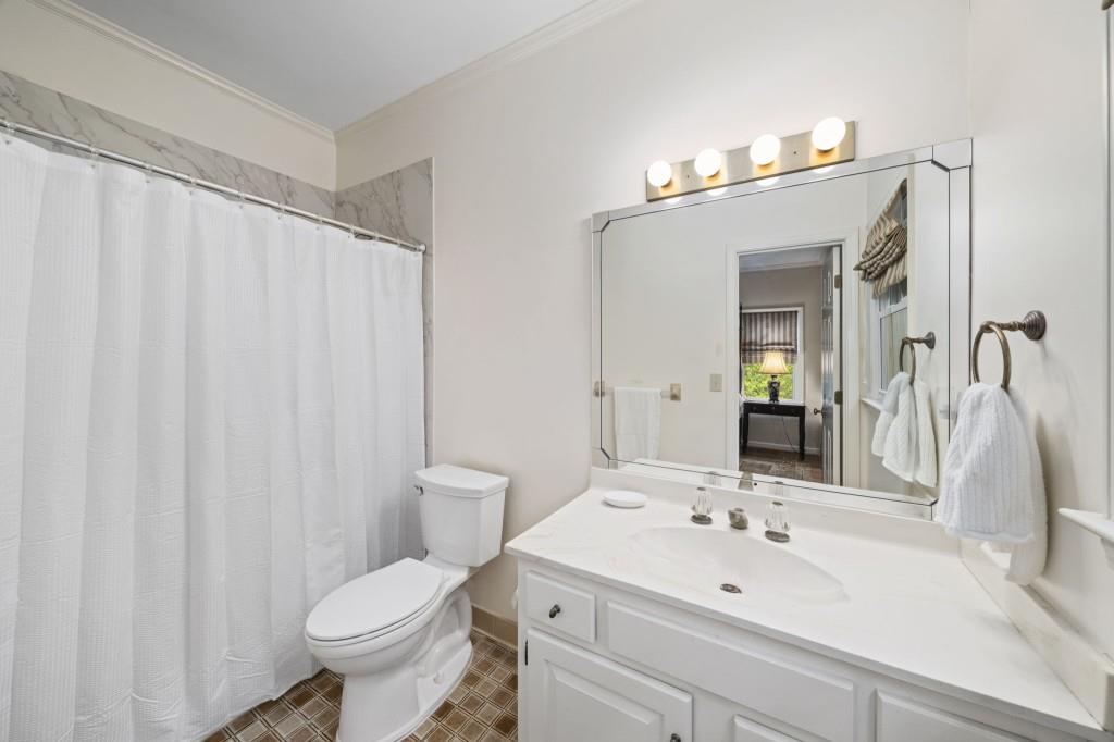 300 Waterpine Court Sandy Springs, GA 30350 - Photo 27 of 53 a bathroom with a sink a toilet and mirror