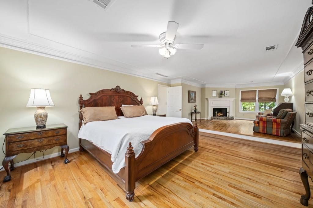 300 Waterpine Court Sandy Springs, GA 30350 - Photo 29 of 53 a bedroom with a bed and wooden floor