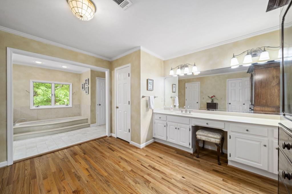 300 Waterpine Court Sandy Springs, GA 30350 - Photo 32 of 53 a spacious bathroom with a sink a mirror and a shower
