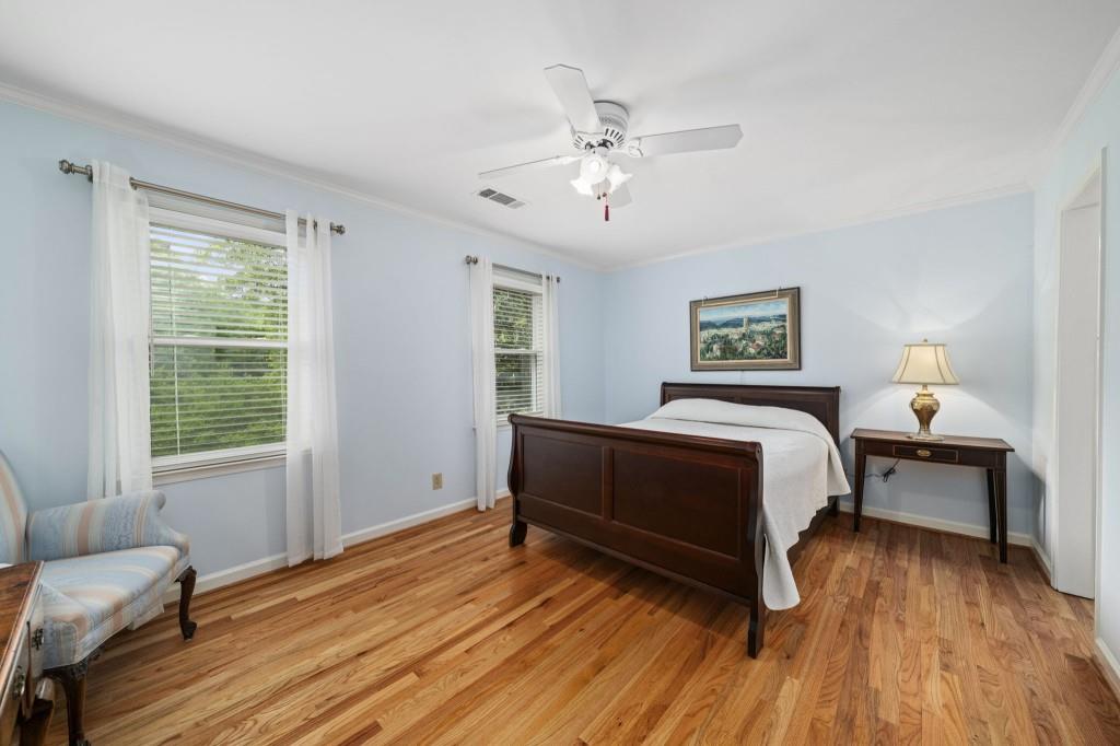 300 Waterpine Court Sandy Springs, GA 30350 - Photo 35 of 53 a bedroom with a bed and wooden floor