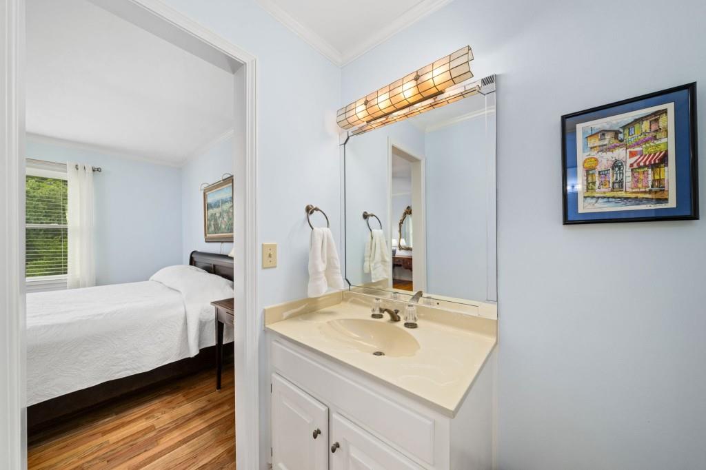 300 Waterpine Court Sandy Springs, GA 30350 - Photo 36 of 53 a en suite bathroom with a sink and a mirror