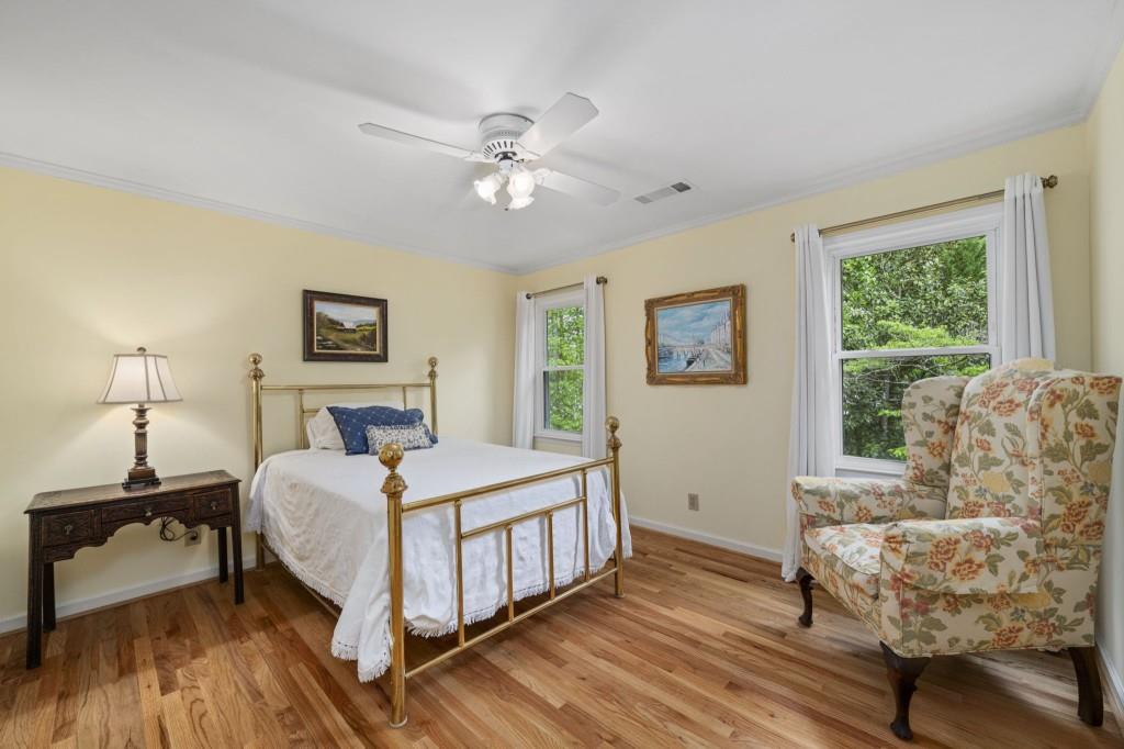 300 Waterpine Court Sandy Springs, GA 30350 - Photo 39 of 53 a bedroom with a bed and a chandelier
