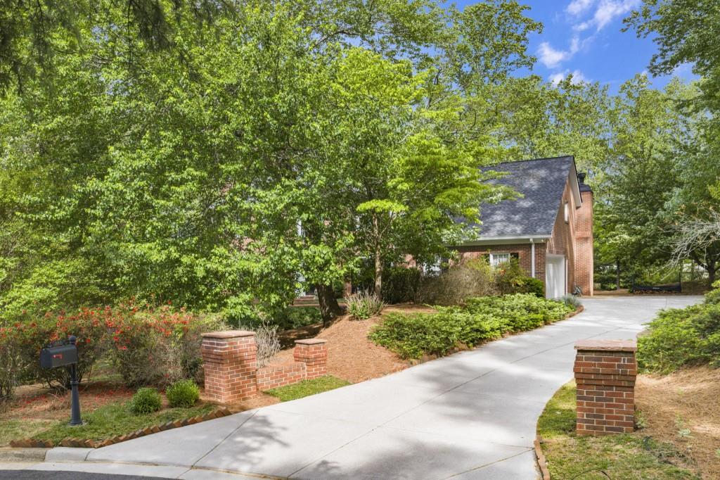 300 Waterpine Court Sandy Springs, GA 30350 - Photo 50 of 53 a front view of a house with a yard and trees