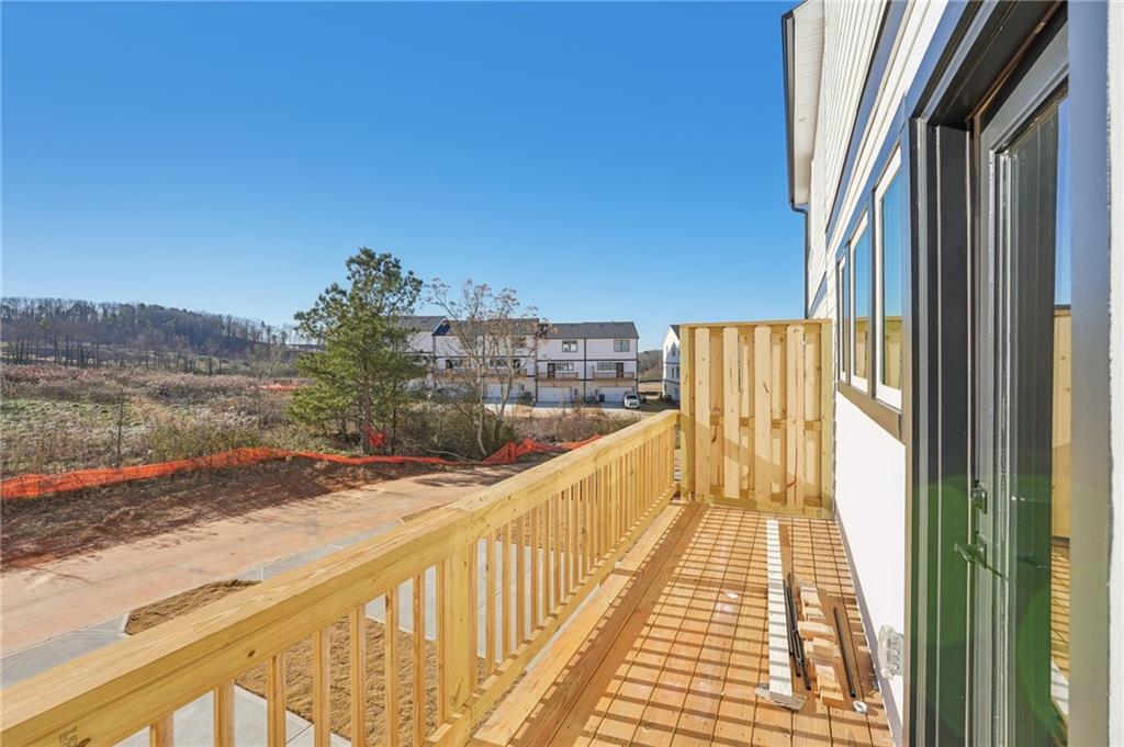 6440 Pinin Place Cumming, GA 30041 - Photo 48 of 52 a view of balcony with wooden floor and fence