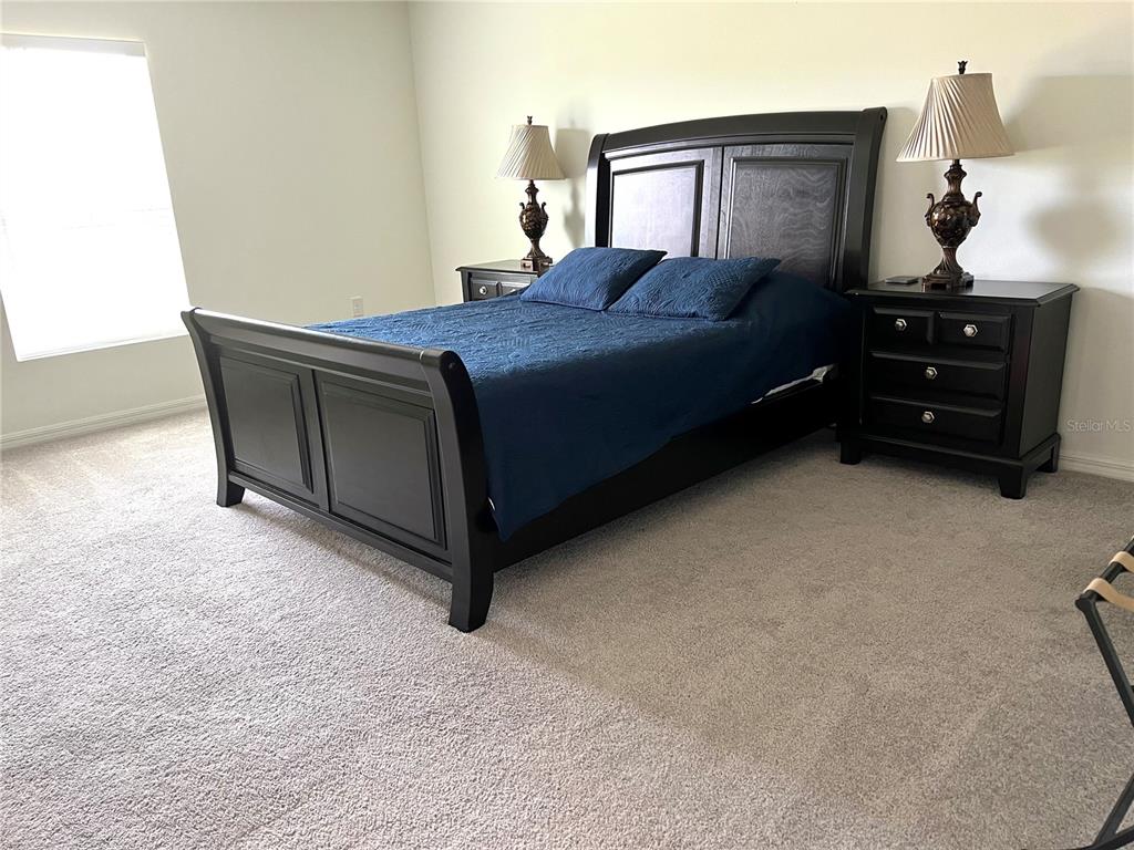 851 Alminar Avenue Southeast Palm Bay, FL 32909 - Photo 12 of 13 a bedroom with a bed and dresser