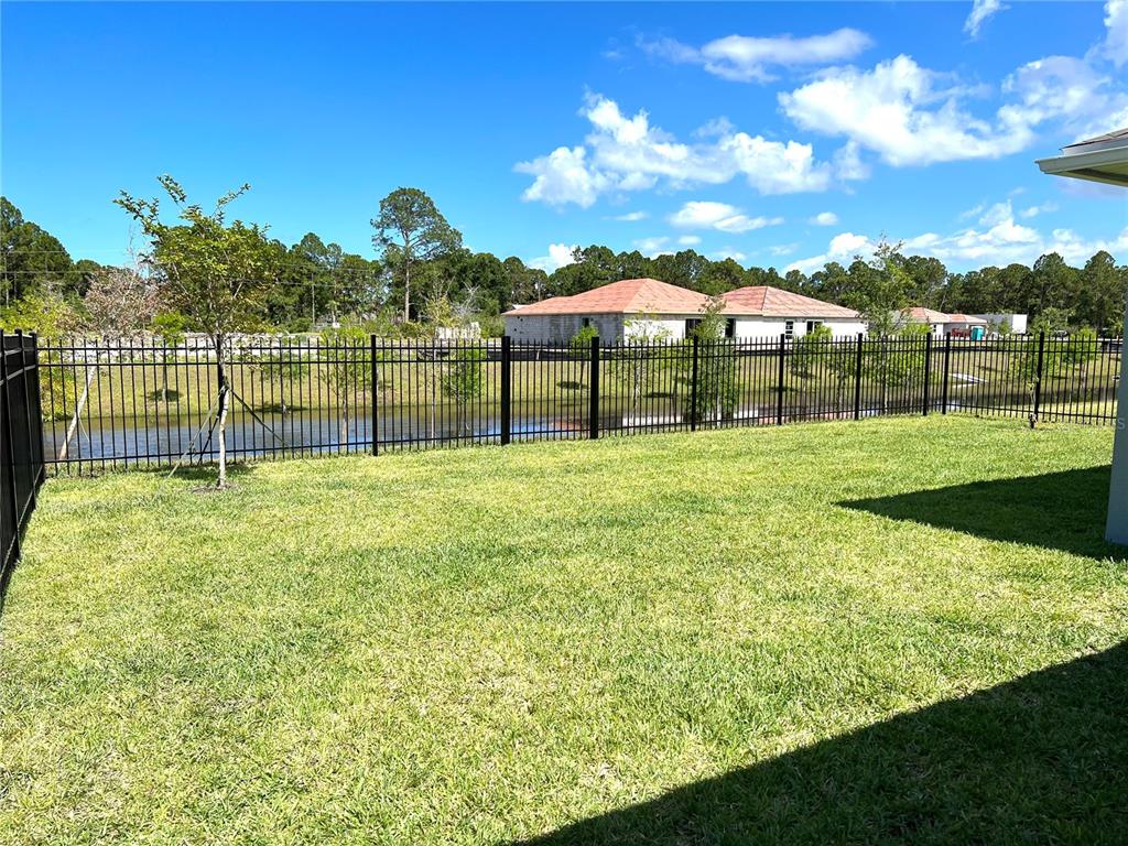 851 Alminar Avenue Southeast Palm Bay, FL 32909 - Photo 3 of 13 a backyard of a house with lots of green space