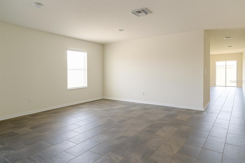 851 Alminar Avenue Southeast Palm Bay, FL 32909 - Photo 5 of 13 an empty room with windows