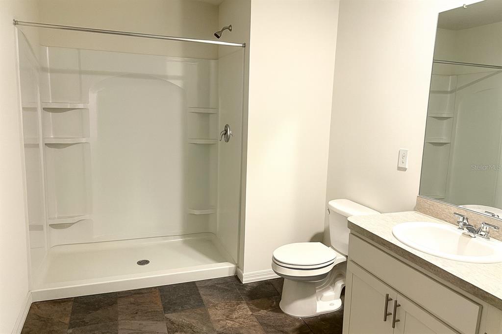 851 Alminar Avenue Southeast Palm Bay, FL 32909 - Photo 7 of 13 a bathroom with a toilet a sink and shower