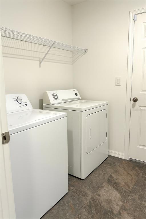 851 Alminar Avenue Southeast Palm Bay, FL 32909 - Photo 9 of 13 a utility room with dryer and washer