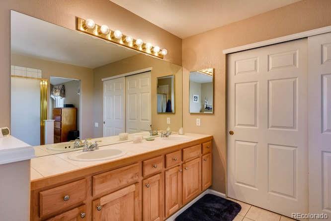 6123 Trailhead Road Highlands Ranch, CO 80130 - Photo 11 of 26 a bathroom with a double vanity sink and a mirror