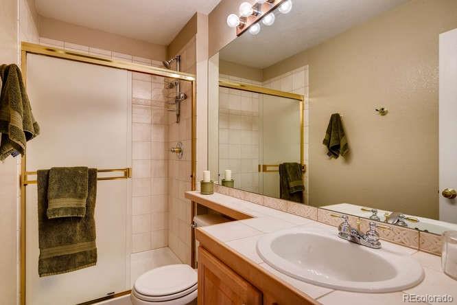 6123 Trailhead Road Highlands Ranch, CO 80130 - Photo 15 of 26 a bathroom with a sink toilet and shower