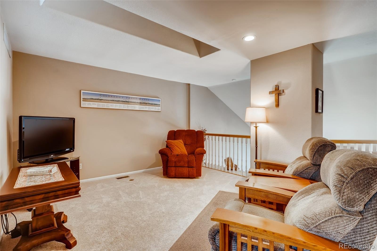 6123 Trailhead Road Highlands Ranch, CO 80130 - Photo 16 of 26 a living room with furniture and a flat screen tv