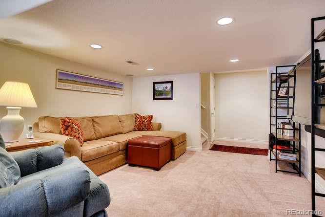 6123 Trailhead Road Highlands Ranch, CO 80130 - Photo 18 of 26 a living room with furniture and a lamp